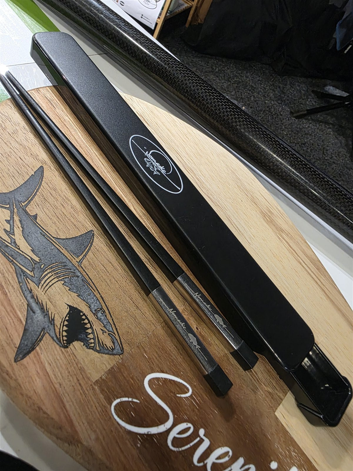 Nomad Chopsticks and their case on a wooden board