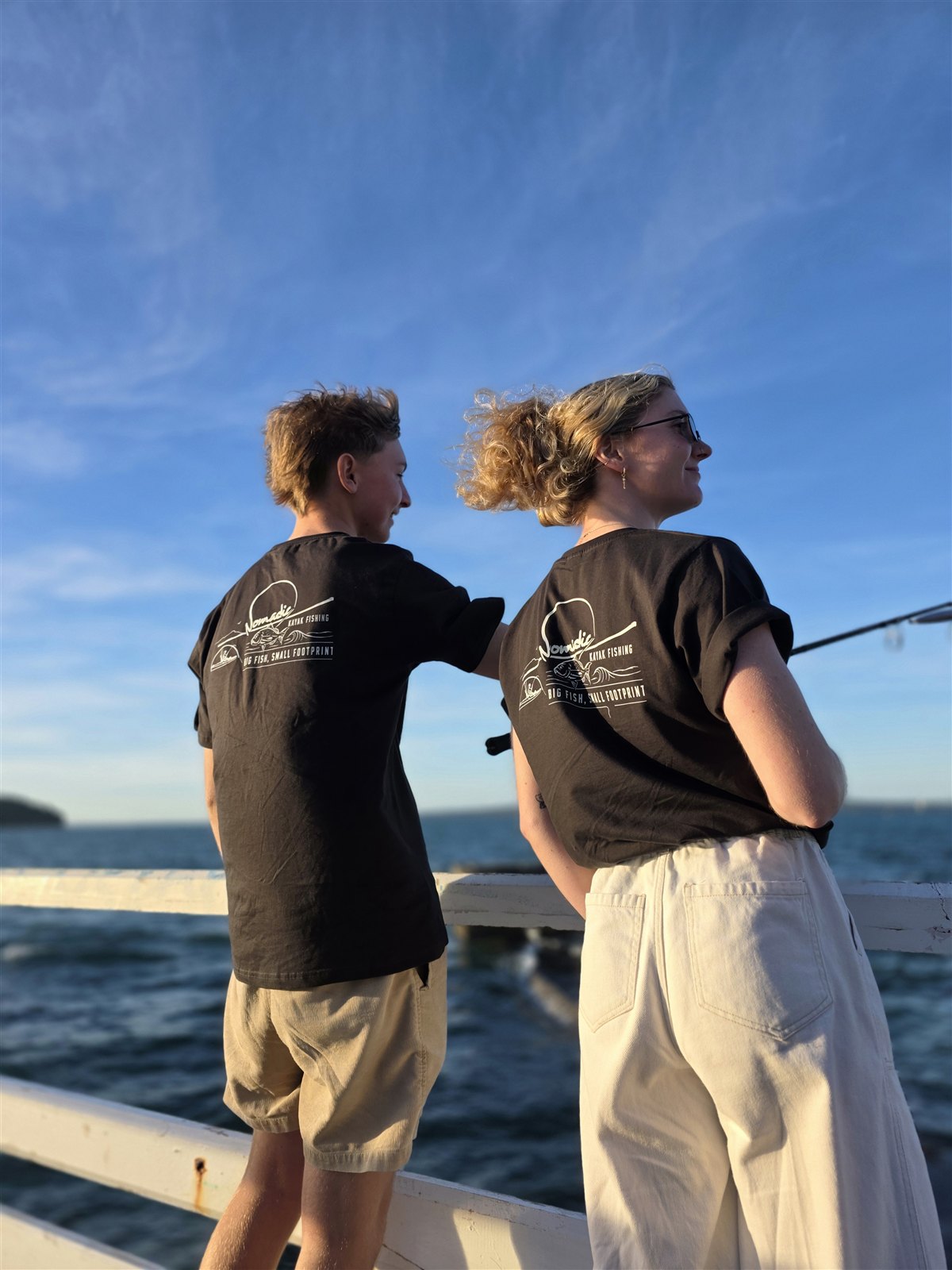 Two anglers wearing Nomadic tees in the sunshine