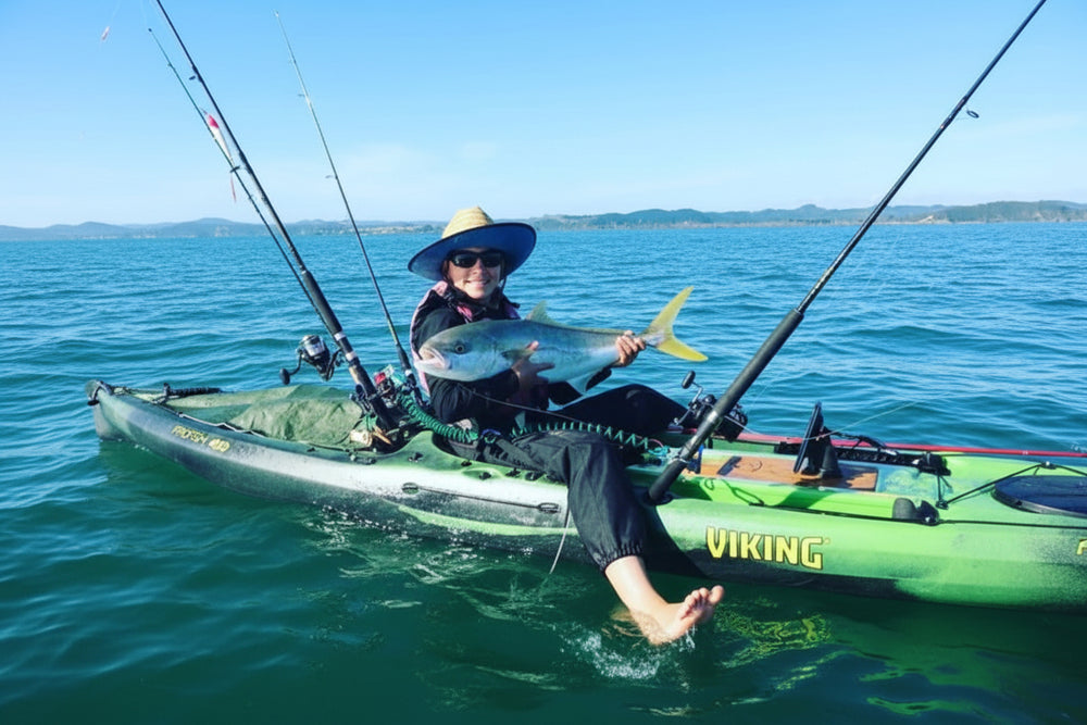 Matt as a young kayak angler holding a kingfish